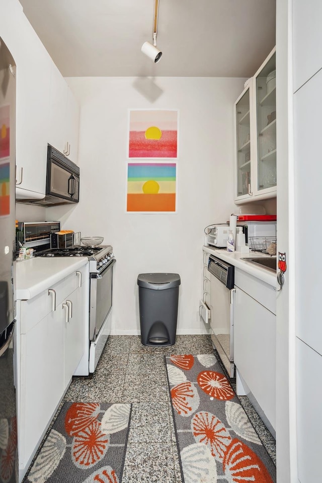 301 W 57th St Unit 40B, New York City, NY 10019 - kitchen with stainless steel gas stove, black microwave, arched walkways, glass insert cabinets, and white dishwasher