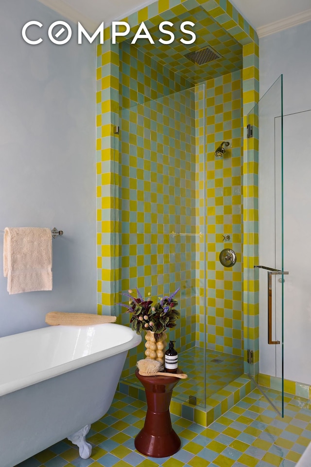 full bath featuring a freestanding tub, a stall shower, and ornamental molding