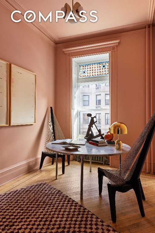 sitting room featuring wood-type flooring and ornamental molding