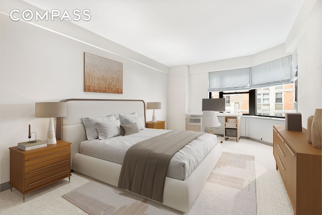 440 E 56th St Unit 8C, New York City, NY 10022 - bedroom featuring light carpet and built in study area