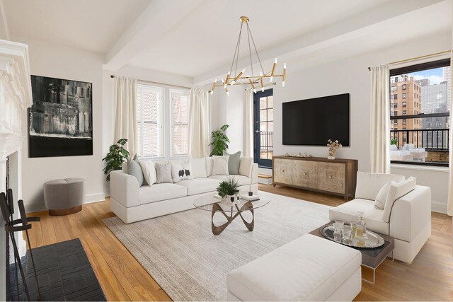 living room with a notable chandelier, beam ceiling, light hardwood / wood-style floors, and a wealth of natural light