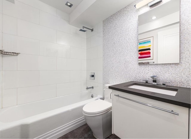 full bathroom featuring toilet, vanity, and tiled shower / bath combo