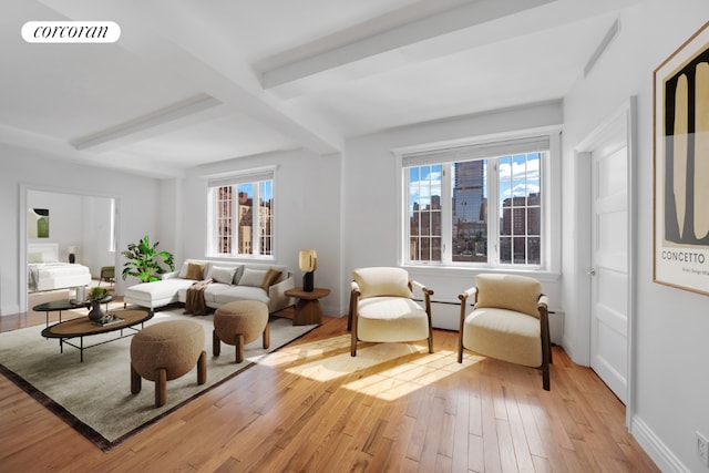 living area featuring light hardwood / wood-style flooring and beamed ceiling