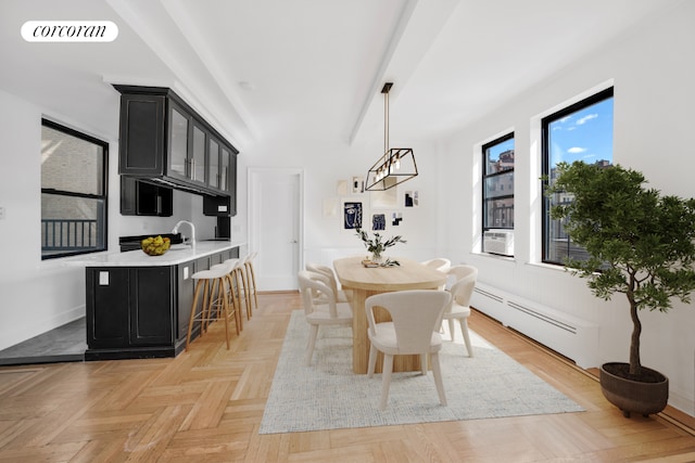 dining room with baseboard heating, a wealth of natural light, light parquet floors, and cooling unit