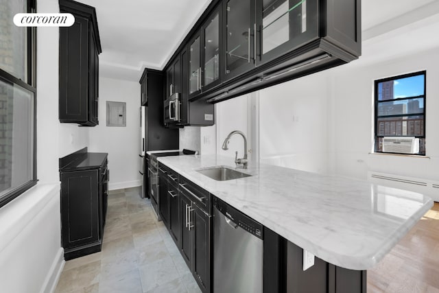 kitchen with stainless steel appliances, baseboard heating, electric panel, light stone counters, and sink