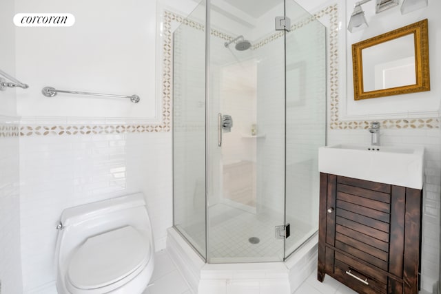 bathroom with toilet, tile walls, a shower with door, and vanity