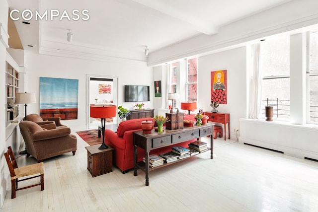 living room featuring hardwood / wood-style floors and beamed ceiling