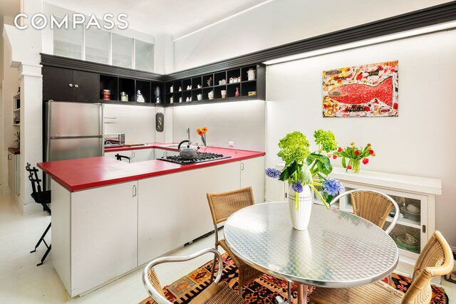 bar with appliances with stainless steel finishes and white cabinets