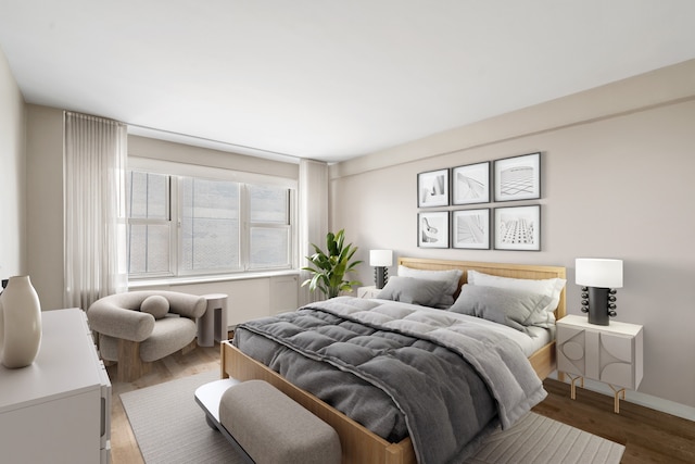bedroom featuring wood finished floors and baseboards