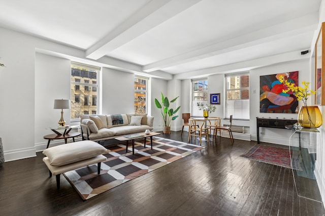 living room featuring beam ceiling, hardwood / wood-style flooring, and baseboards