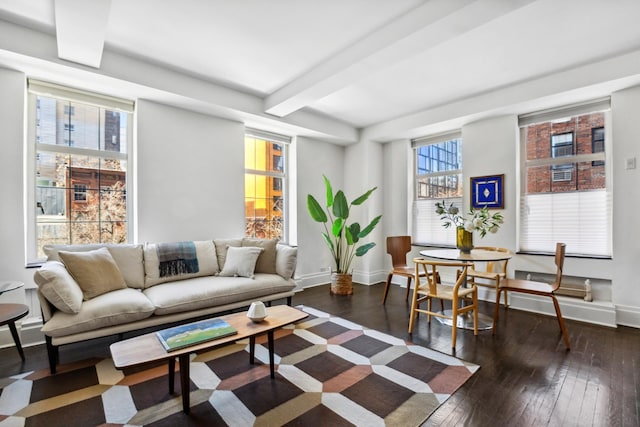 living room with beamed ceiling, baseboards, and dark wood-type flooring