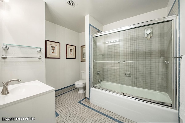 full bathroom featuring bath / shower combo with glass door, visible vents, toilet, vanity, and tile patterned floors