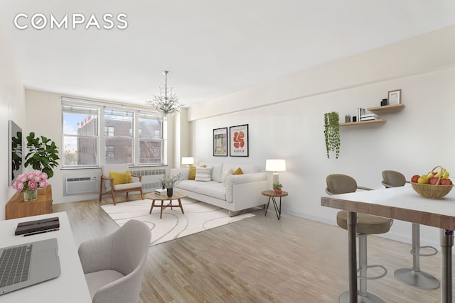 living area featuring radiator heating unit, a wall mounted air conditioner, an inviting chandelier, and wood finished floors