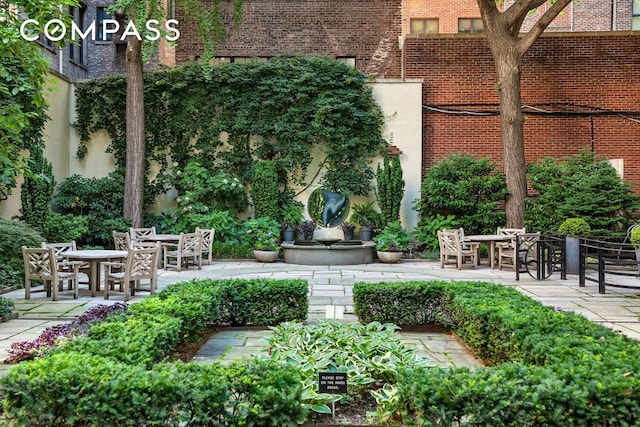 view of property's community featuring a patio area and outdoor dining space