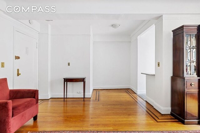 living area with wood finished floors and baseboards