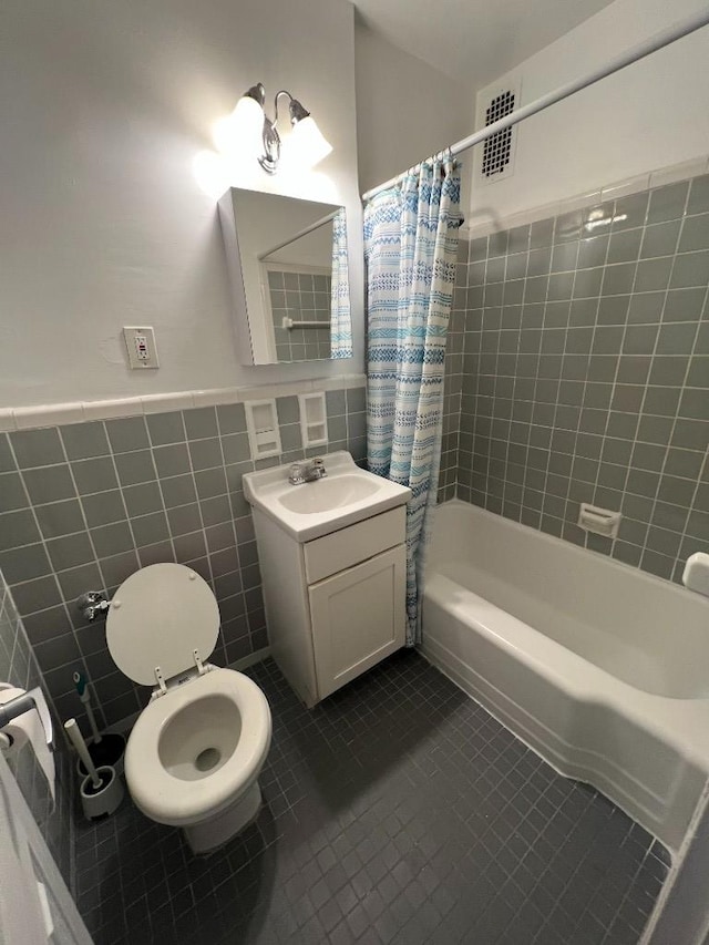 bathroom with visible vents, toilet, tile walls, shower / bath combination with curtain, and tile patterned flooring