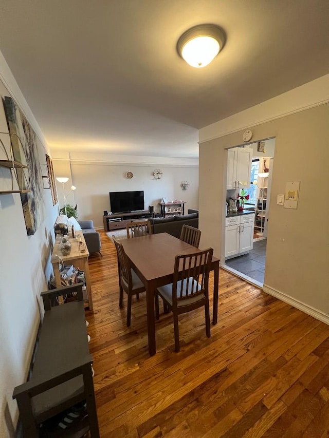 dining area featuring dark wood-style floors and baseboards