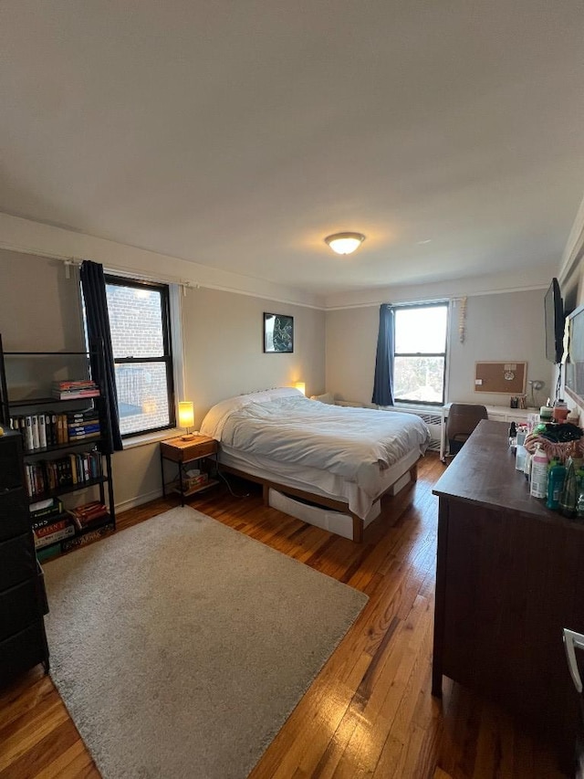 bedroom featuring crown molding and hardwood / wood-style flooring