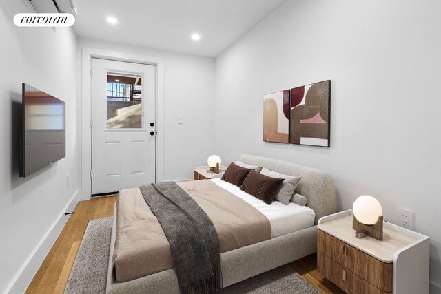 bedroom featuring light wood-type flooring, visible vents, baseboards, and recessed lighting