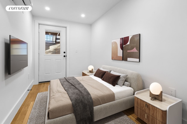 bedroom with light wood-style floors, recessed lighting, and baseboards