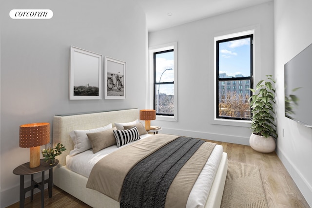 bedroom featuring visible vents, baseboards, and wood finished floors