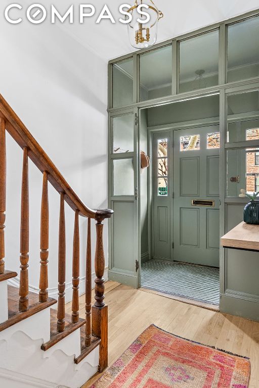 foyer entrance with light hardwood / wood-style floors