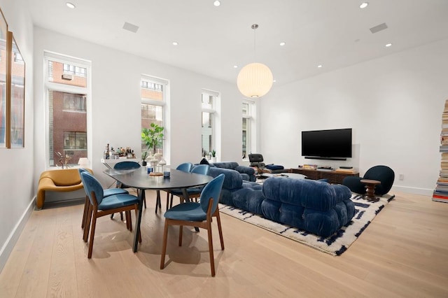 dining area with light wood finished floors, recessed lighting, and baseboards