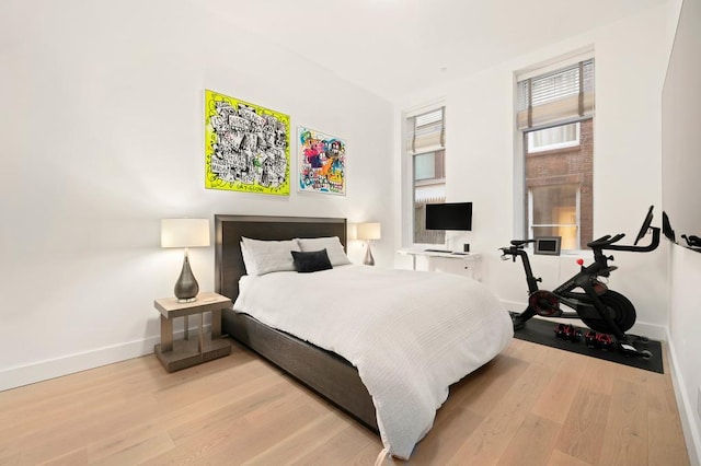 bedroom with baseboards and wood finished floors