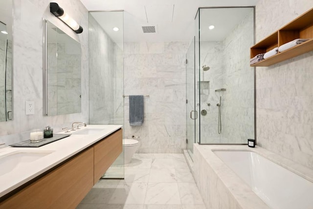 bathroom featuring a shower stall, marble finish flooring, toilet, a garden tub, and double vanity