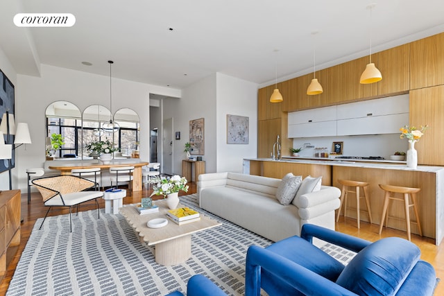 living room with sink and light hardwood / wood-style floors