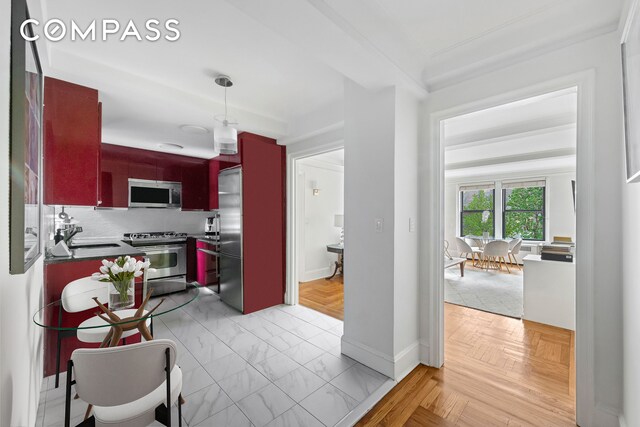 kitchen featuring stainless steel appliances, tasteful backsplash, light parquet floors, and sink