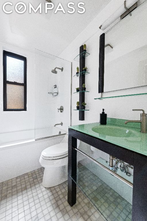 full bathroom with toilet, vanity, and  shower combination