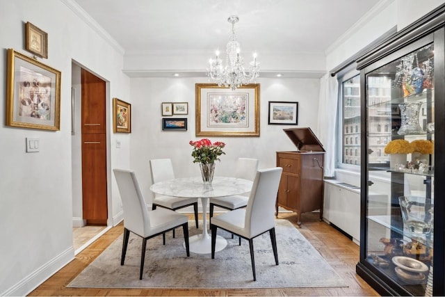 dining space featuring light parquet floors, ornamental molding, and a chandelier