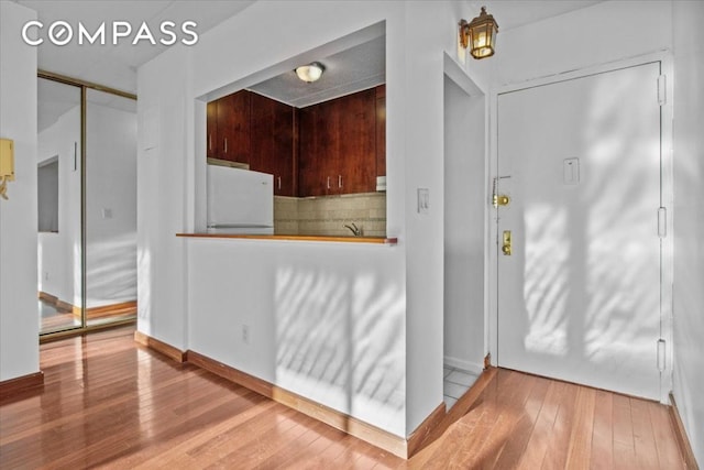 kitchen featuring white refrigerator and hardwood / wood-style flooring