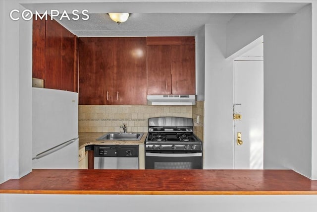 kitchen featuring black range with gas cooktop, sink, stainless steel dishwasher, white fridge, and decorative backsplash