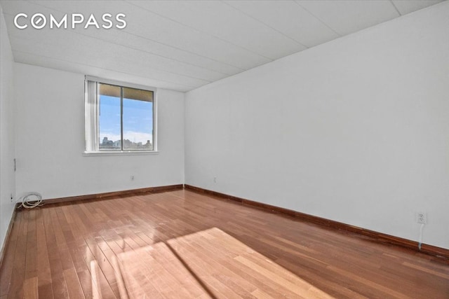 unfurnished room featuring hardwood / wood-style floors