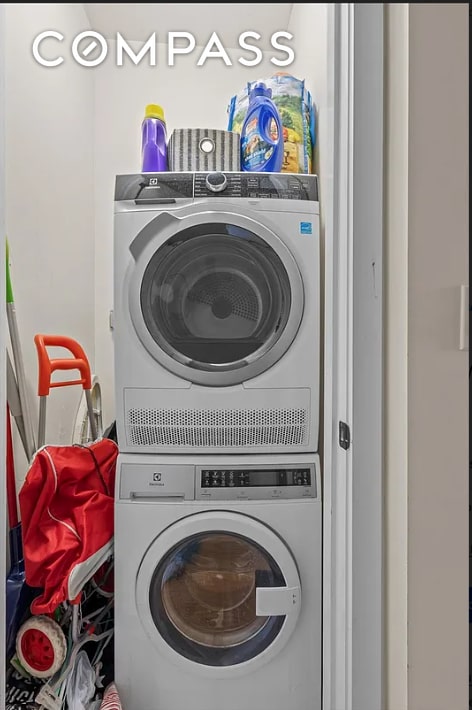 washroom featuring laundry area and stacked washer / drying machine