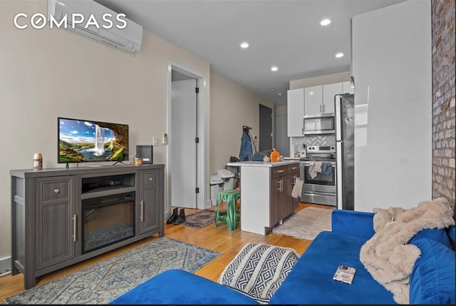 living area with recessed lighting and light wood finished floors