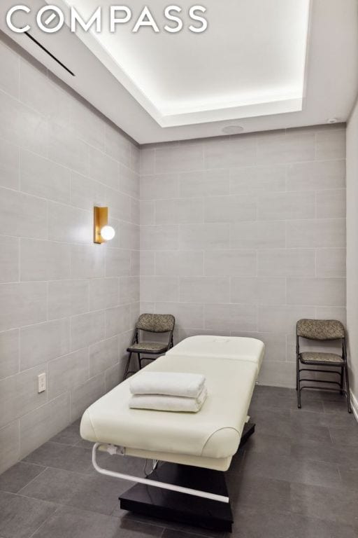 bathroom with tile walls and tile patterned flooring