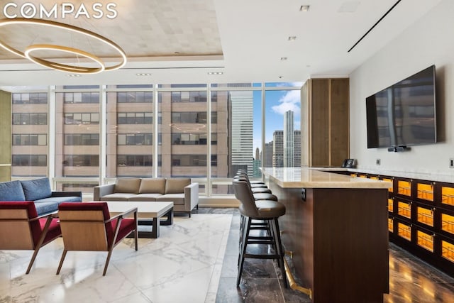 interior space featuring floor to ceiling windows and a tray ceiling