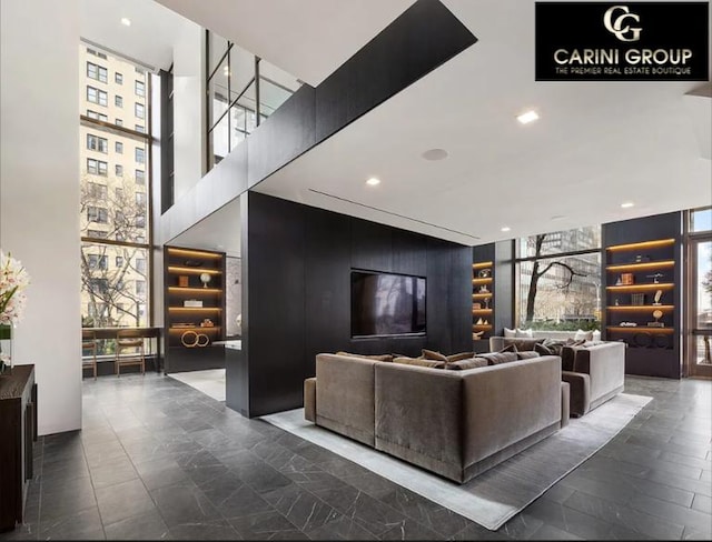 living area featuring recessed lighting and a wall of windows