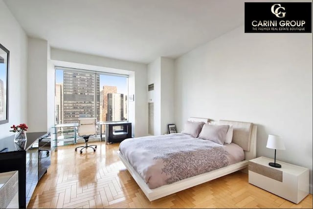 bedroom with light parquet floors