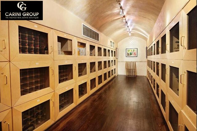 845 United Nations Plz Unit 36C, New York City, NY 10017 - wine area with vaulted ceiling, hardwood / wood-style floors, and rail lighting