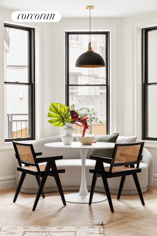 dining space featuring breakfast area and baseboards