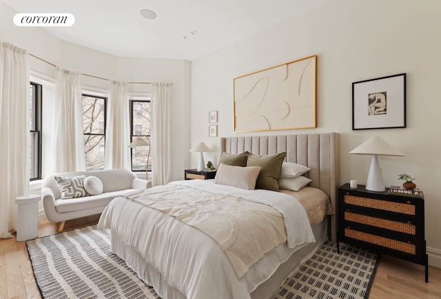 bedroom with visible vents and wood finished floors