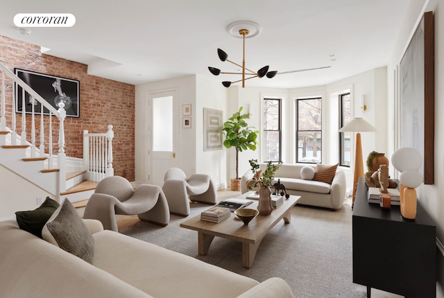 carpeted living room featuring visible vents, brick wall, and stairs