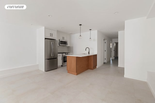 kitchen featuring stainless steel appliances, light countertops, visible vents, white cabinetry, and a peninsula