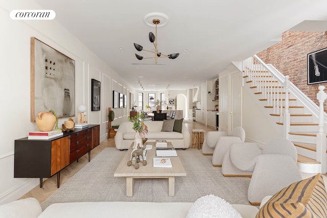 living room featuring arched walkways, visible vents, and stairs