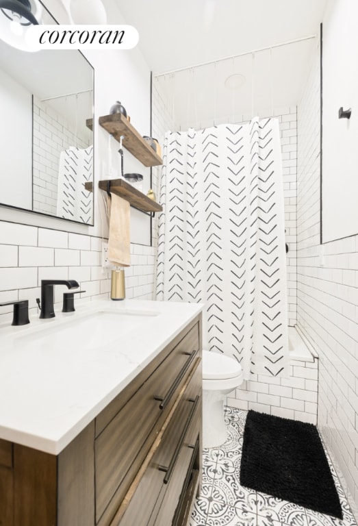 bathroom featuring vanity, decorative backsplash, tile walls, toilet, and a shower with shower curtain