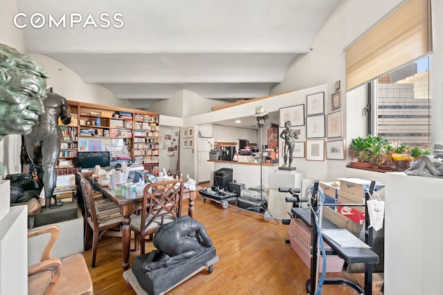 office with beam ceiling and hardwood / wood-style flooring